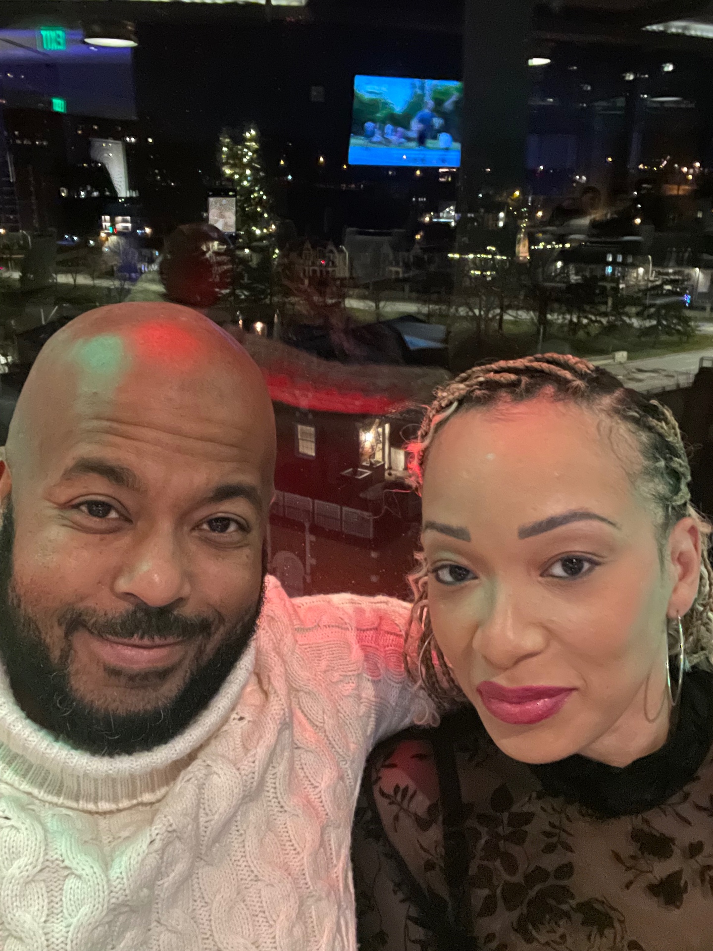 Remy with his partner at a city view restaurant