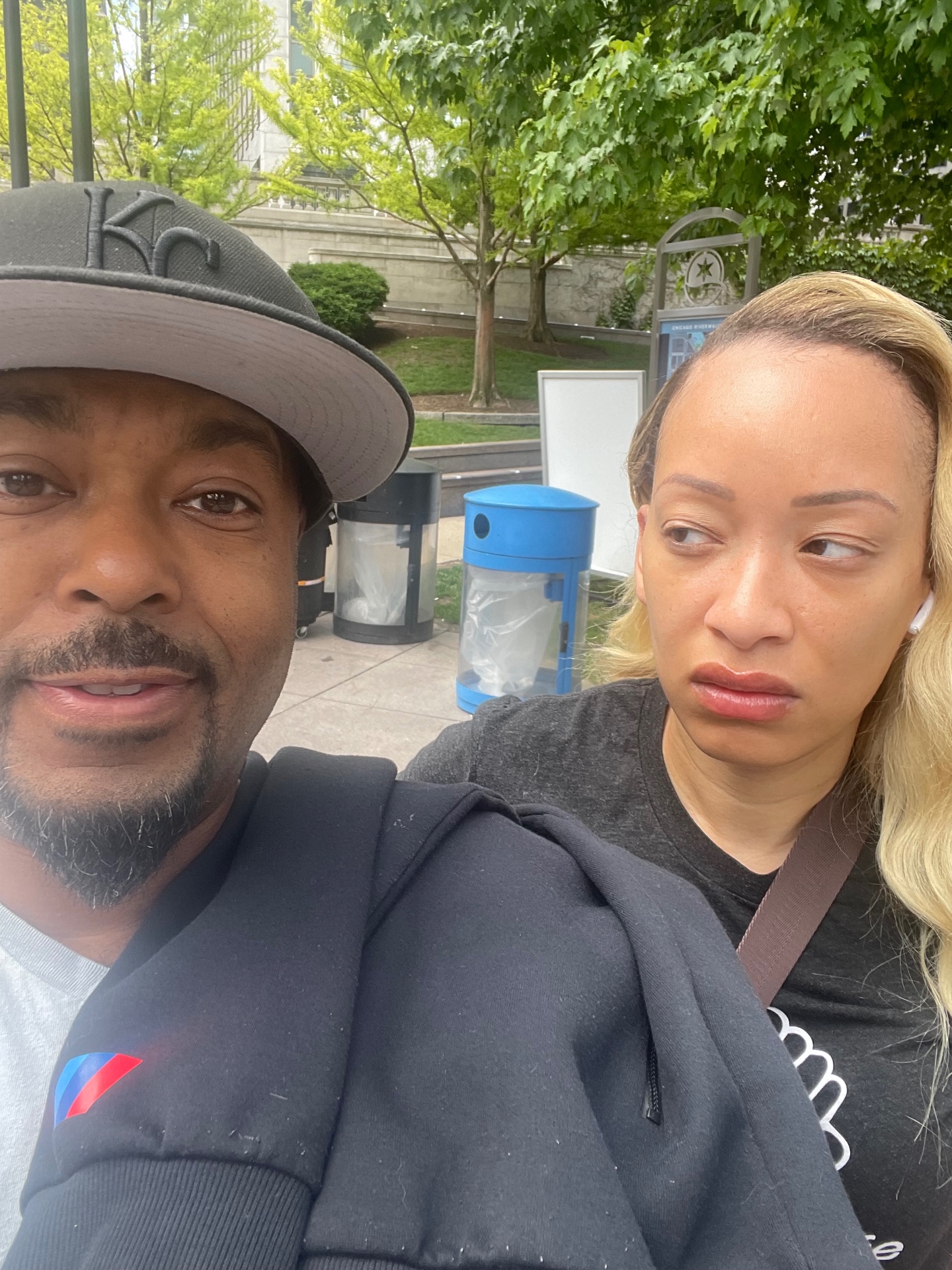Remy taking a selfie while his wife side-eyes him